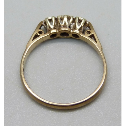 984 - A 9ct gold ring set with three small diamonds, 2g, O