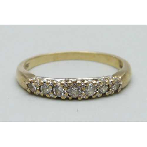 986 - A 9ct gold ring set with seven diamonds, 1.8g, N