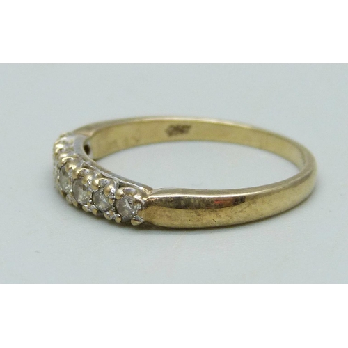 986 - A 9ct gold ring set with seven diamonds, 1.8g, N