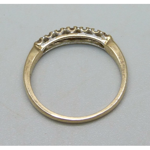 986 - A 9ct gold ring set with seven diamonds, 1.8g, N