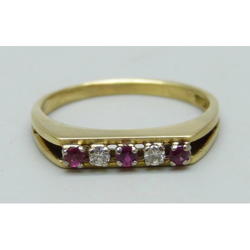 987 - An 18ct gold ring set with three red stones and two diamonds, 3.2g, O