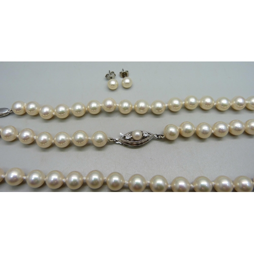 999 - A faux pearl necklace and bracelet with silver clasps, and a pair of unmarked earrings