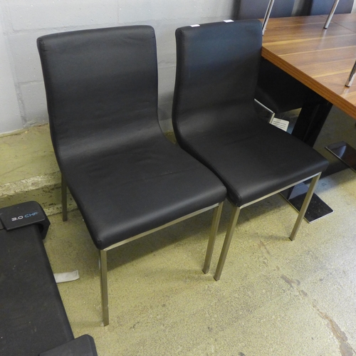 1572 - A pair of black and chrome leather effect dining chairs