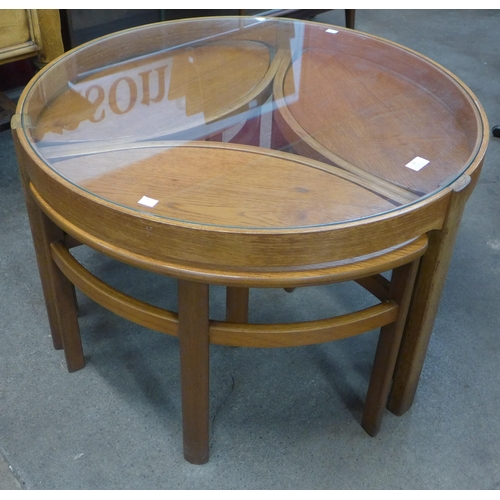 10 - A Nathan Trinity teak and glass topped circular nest of tables