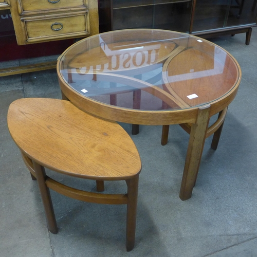 10 - A Nathan Trinity teak and glass topped circular nest of tables