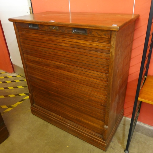 122 - An early 20th Century oak tambour front fitted cabinet