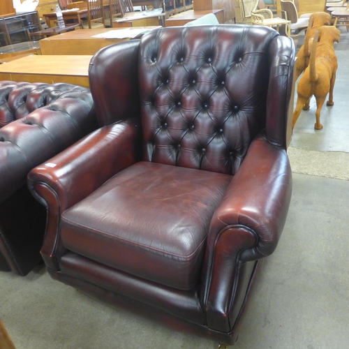 125 - A Thames Lloyd burgundy leather Chesterfield wingback armchair