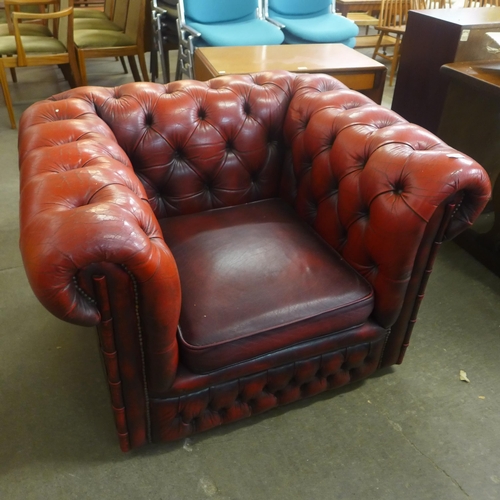 126 - An oxblood red leather Chesterfield club chair