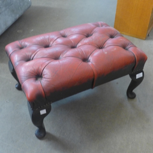 127 - An oxblood red leather Chesterfield footstool