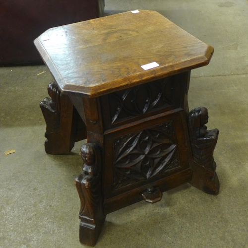 132 - A Victorian Gothic Revival carved oak stool