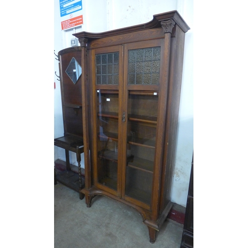 136 - An Arts and Crafts oak two door bookcase