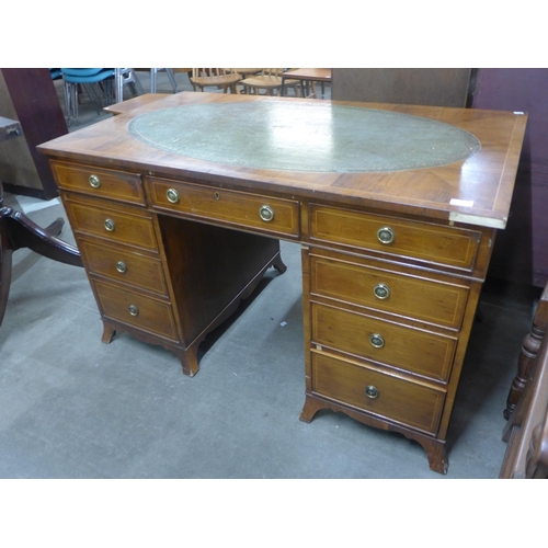 141 - A George III style inlaid yew wood and green leather topped pedestal desk