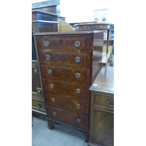 144 - A George III style walnut chest of drawers