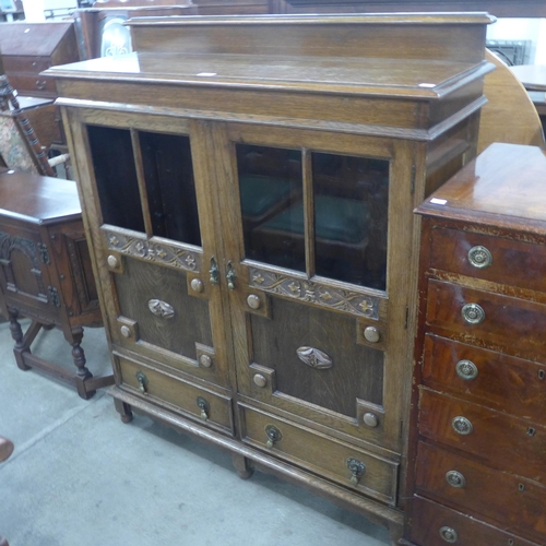 145 - An early 20th Century carved oak two door bookcase