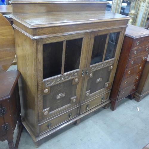 145 - An early 20th Century carved oak two door bookcase