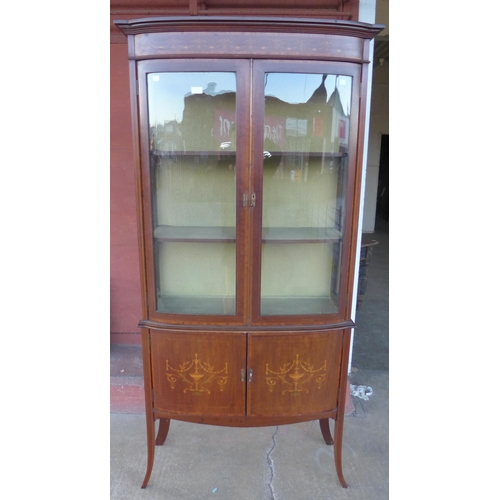 151 - An Edward VII inlaid mahogany bow front display cabinet