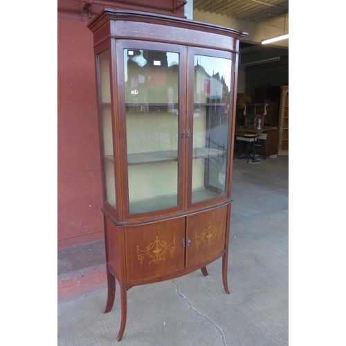 151 - An Edward VII inlaid mahogany bow front display cabinet