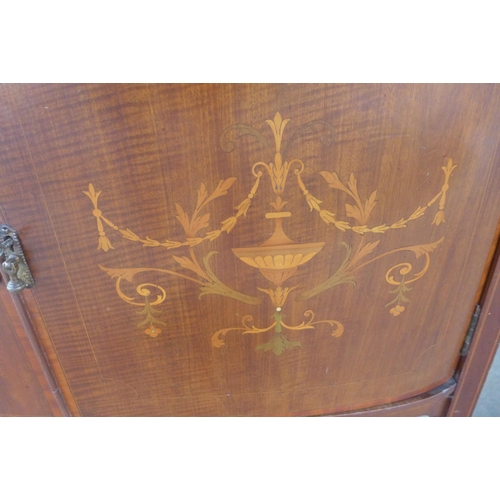 151 - An Edward VII inlaid mahogany bow front display cabinet