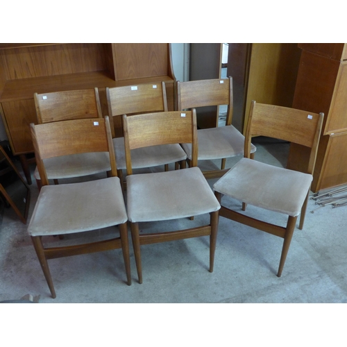 16 - A set of six teak dining chairs