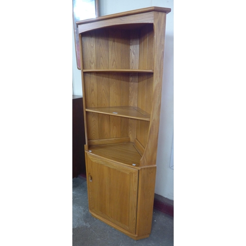 21 - An Ercol Blonde ash freestanding corner cabinet