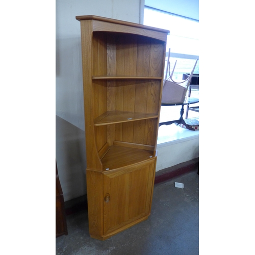 21 - An Ercol Blonde ash freestanding corner cabinet