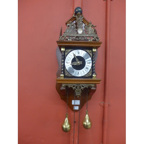 331 - A Dutch mahogany and brass wall hanging clock