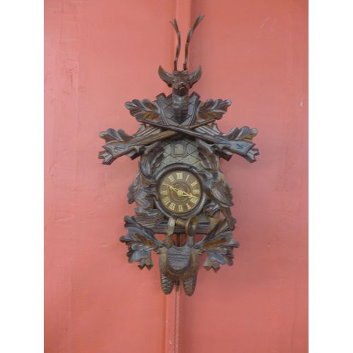 332 - A Black Forest carved wood cuckoo clock