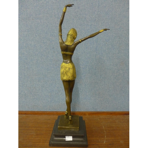 361 - An Art Deco style bronze and parcel gilt figure of an exotic female dancer, on marble socle