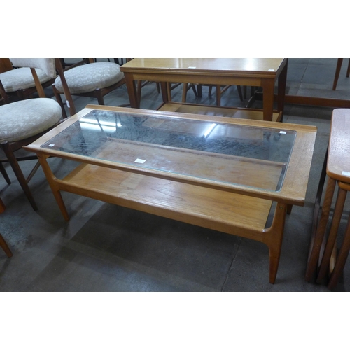 50 - A teak and glass topped rectangular coffee table