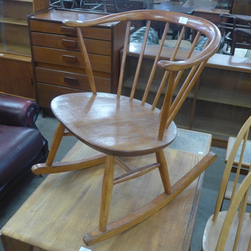 60 - An Ercol elm and beech 452 model cow horn fireside rocking chair