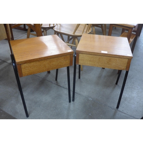 77 - A pair of teak single drawer bedside tables, on black tubular metal stands