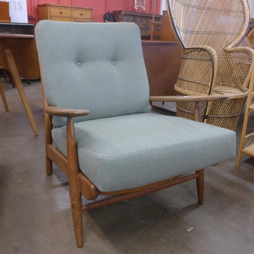 84 - A Cintique teak fireside armchair