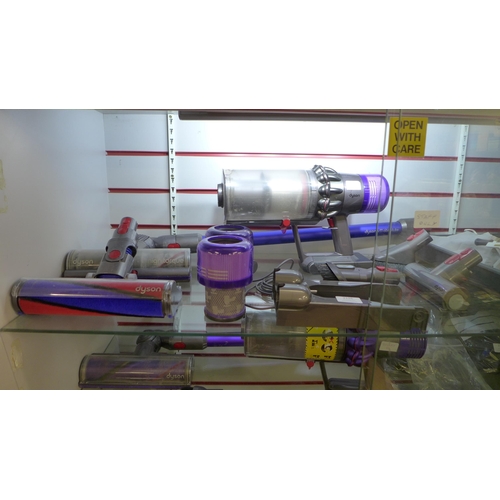 2126 - A Dyson V11 Absolute vacuum cleaner with charger, dock, replacement filters, and all attachments