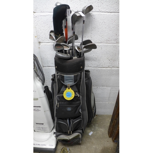 2232 - A golf bag with approximately twenty assorted clubs