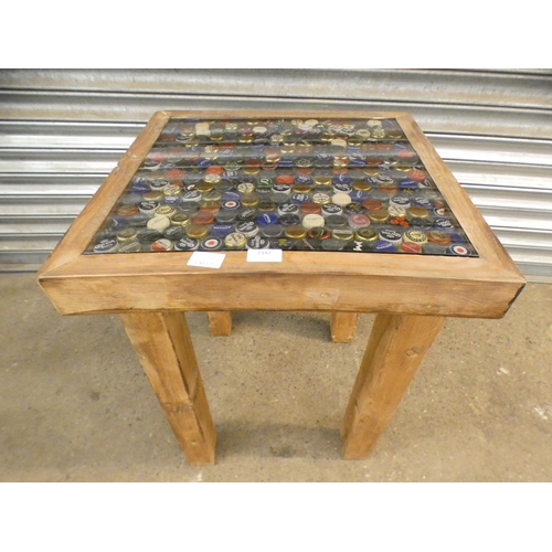 2342 - A beer bottle top inlaid garden table