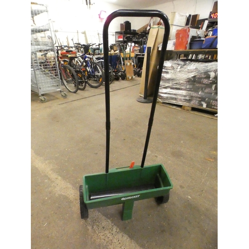 2344 - A hand cylinder mower, a lawn feeder/seed spreader, two gardening forks and a garden trowel