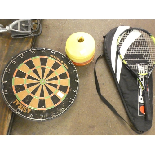 2548 - A dartboard, football training cones, and two tennis racquets