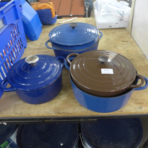 2404 - Four cast metal pots (two Le Creuset)