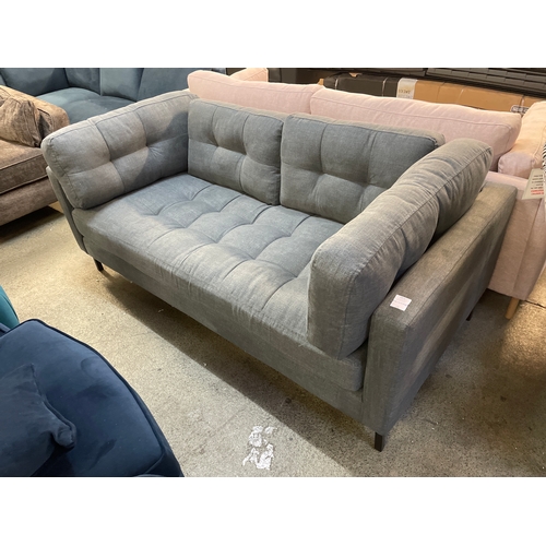 1471 - A grey upholstered pinched back two seater sofa on black metal legs