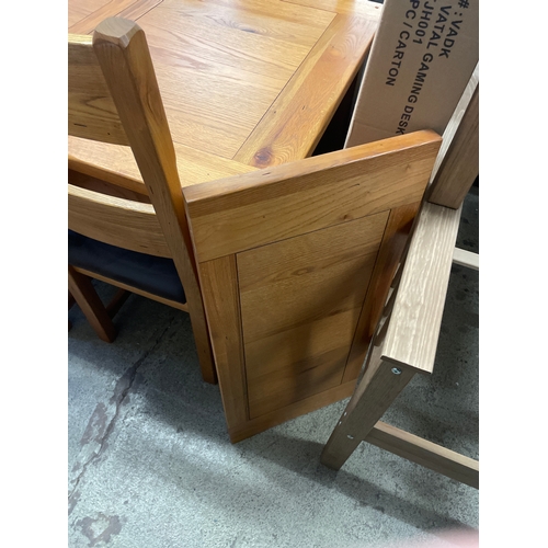 1571 - An oak extending dining table and a set of four dining chairs with leather seats