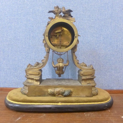 368A - A 19th Century French gilt spelter mantel clock  with girl on a swing