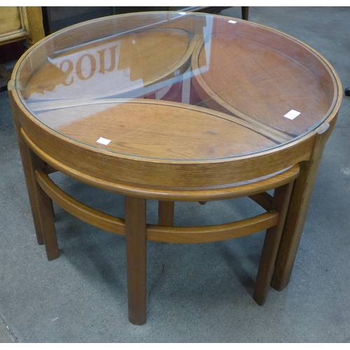 3 - A Nathan Trinity teak and glass topped circular nest of tables