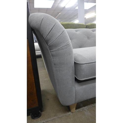 1379 - A light grey upholstered modern Chesterfield style large three seater sofa