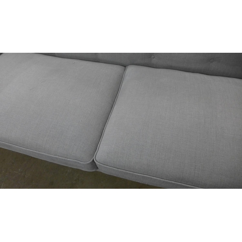 1379 - A light grey upholstered modern Chesterfield style large three seater sofa
