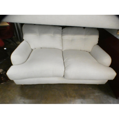 1403 - An ivory upholstered three and two seater sofa on turned legs RRP £1798