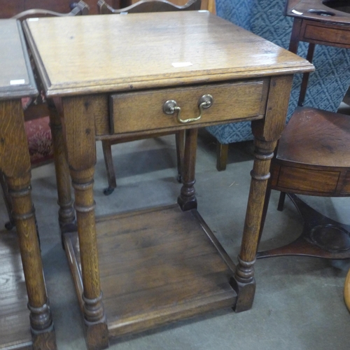 176 - A George III style oak single drawer lamp table