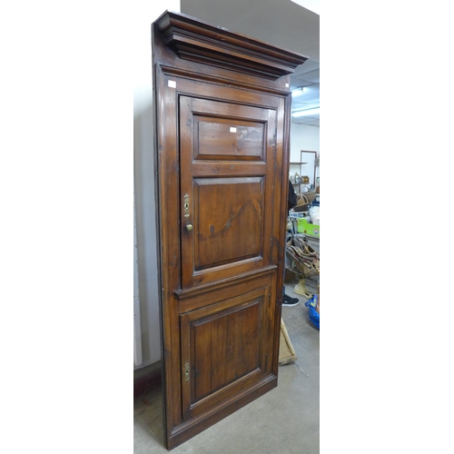 273 - A George III stained pine freestanding corner cupboard