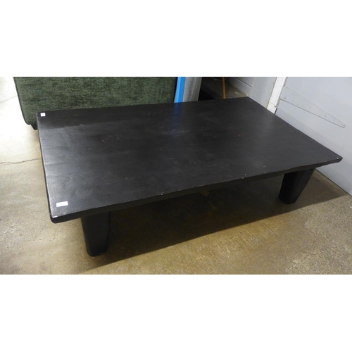 1409 - A large black timber coffee table * this lot is subject to VAT