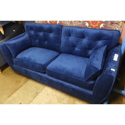 1414 - A blue velvet Hoxton three seater sofa - RRP £799