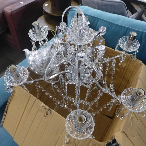 1451 - A chrome six arm chandelier with glass droplets